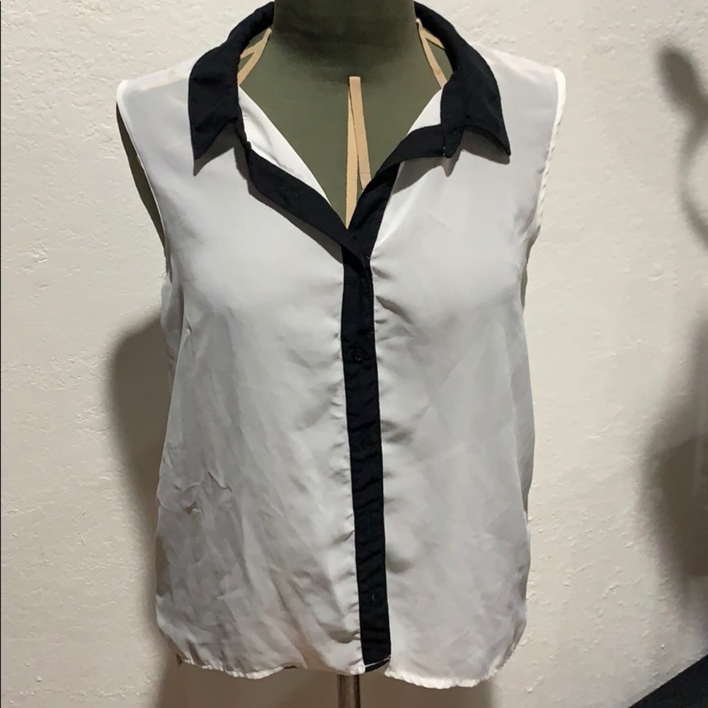 Sheer white sleeveless blouse with black trim.